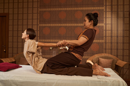 Therapist performing Thai massage